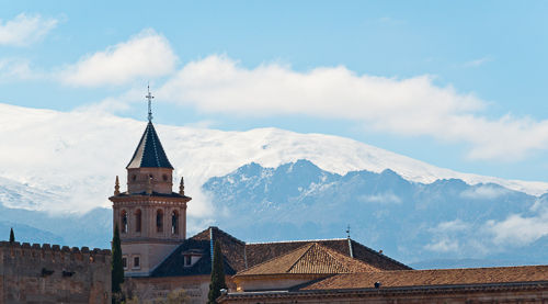 The Alhambra in front of mountains of the Sierra Nevada.