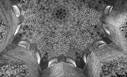 Fine ornaments cover the ceiling of a room.